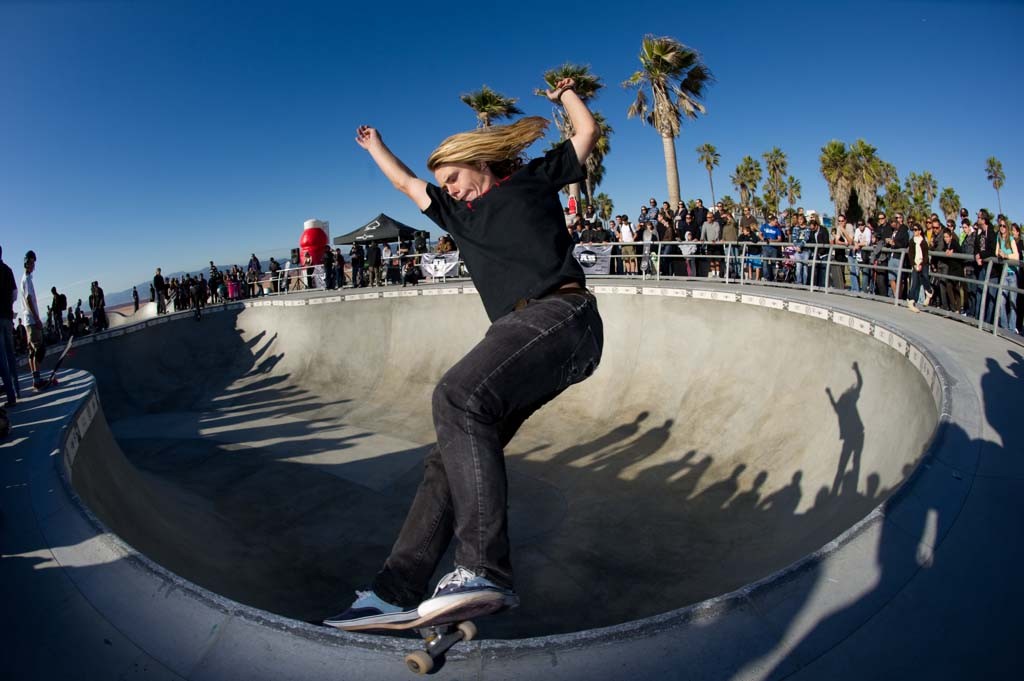 A skateboarder performing a Smith grind.