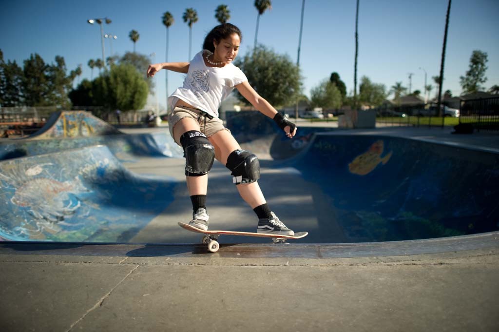 A skateboarder performing a Smith grind.