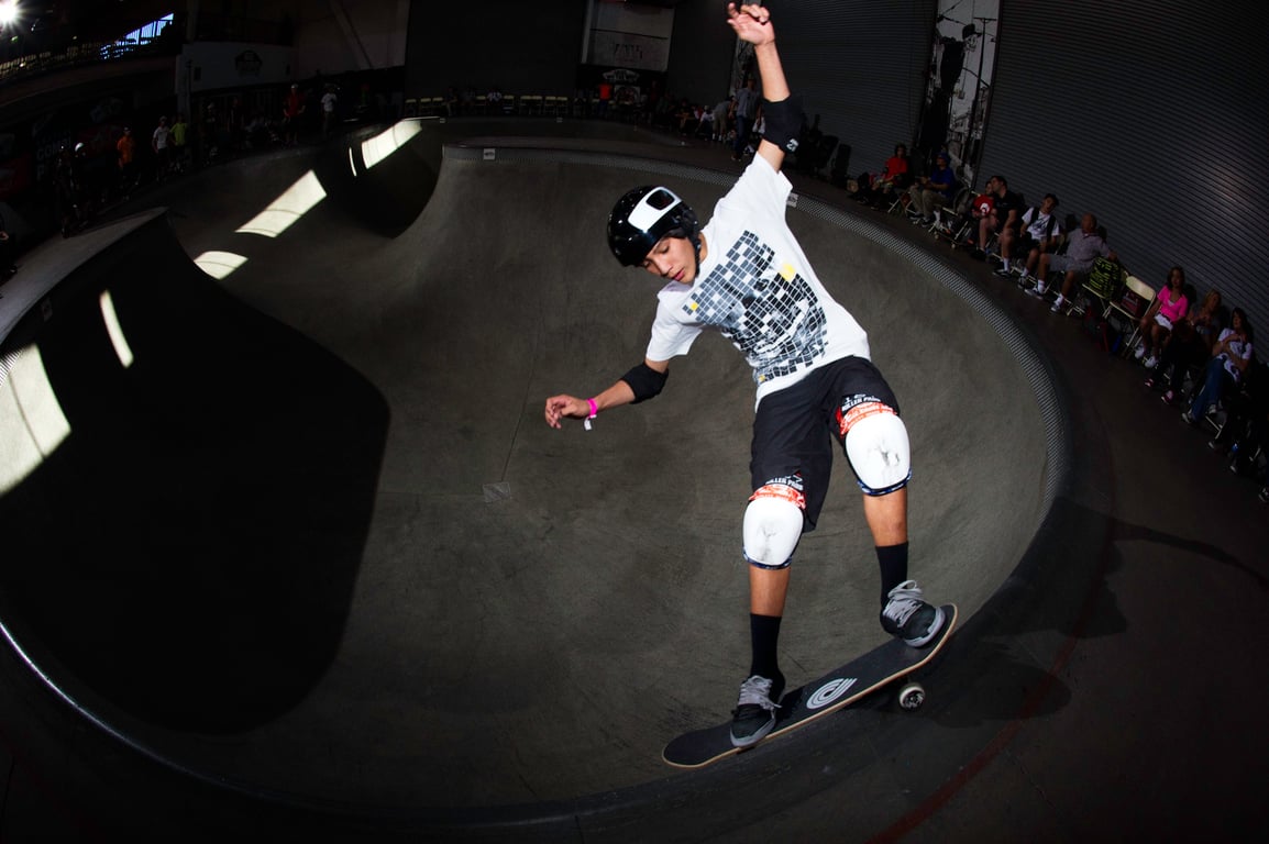 A skateboarder performing a Smith grind.