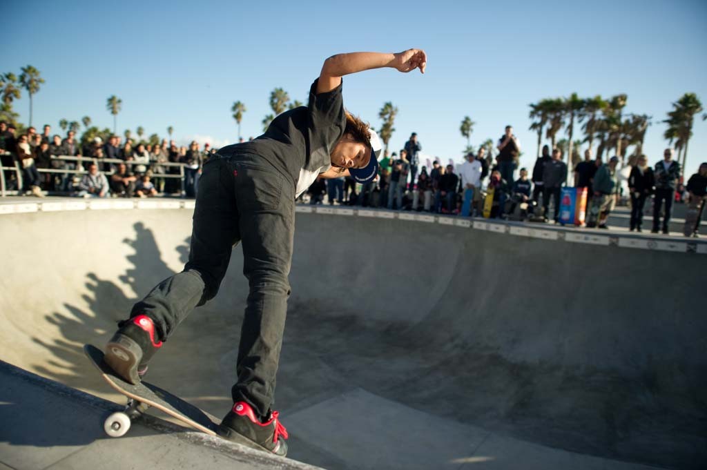 A skateboarder performing a Smith grind.