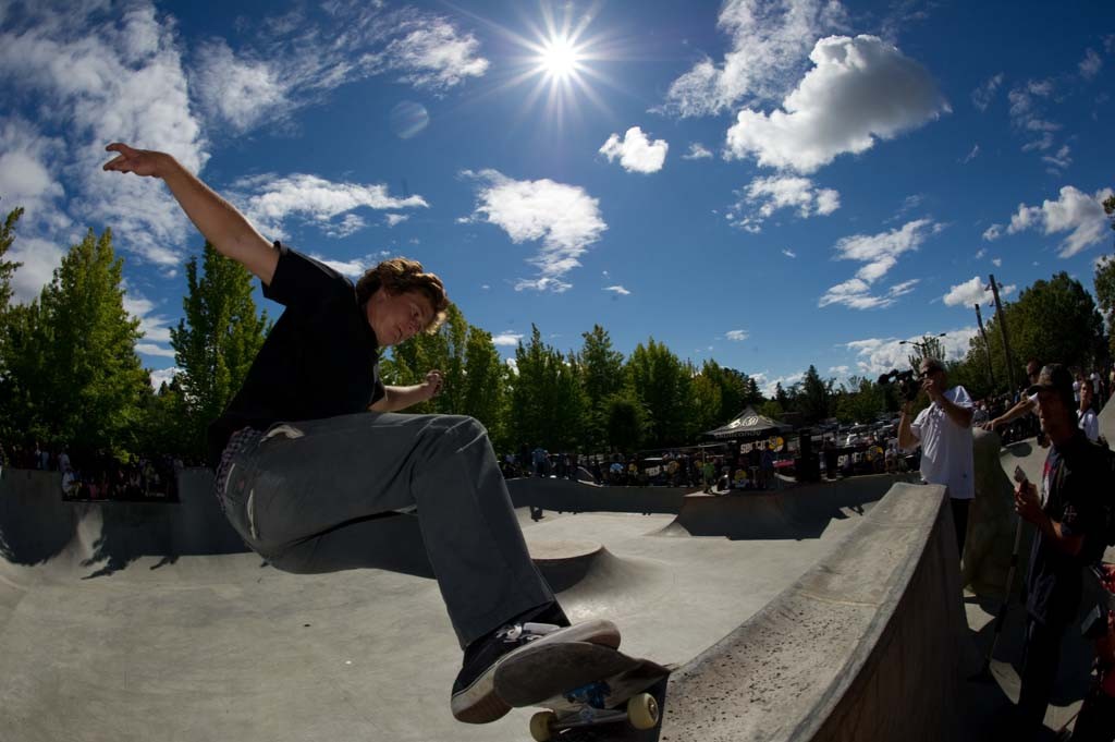 A skateboarder performing a Smith grind.