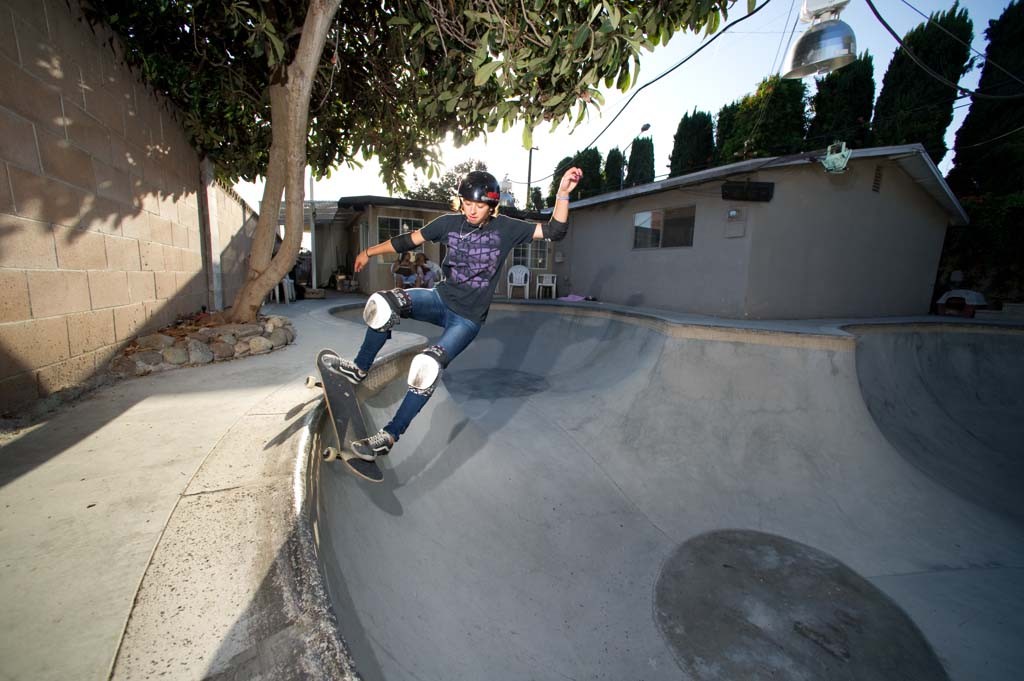 A skateboarder performing a Smith grind.