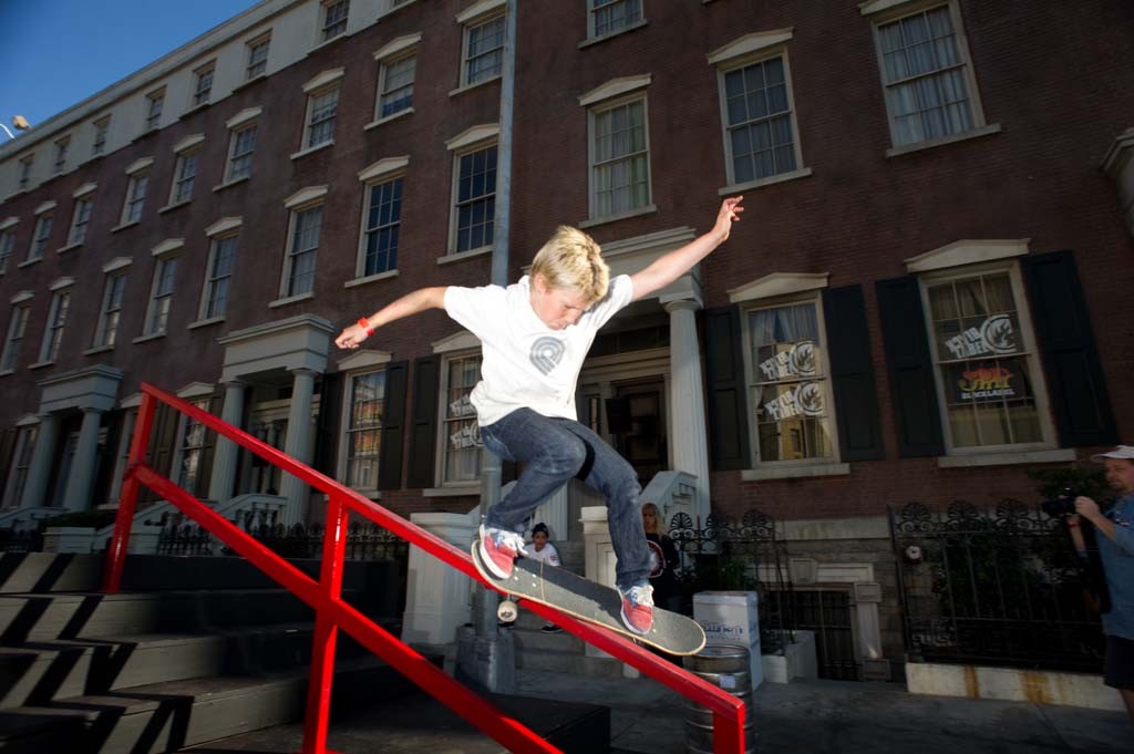 A skateboarder performing a Smith grind.
