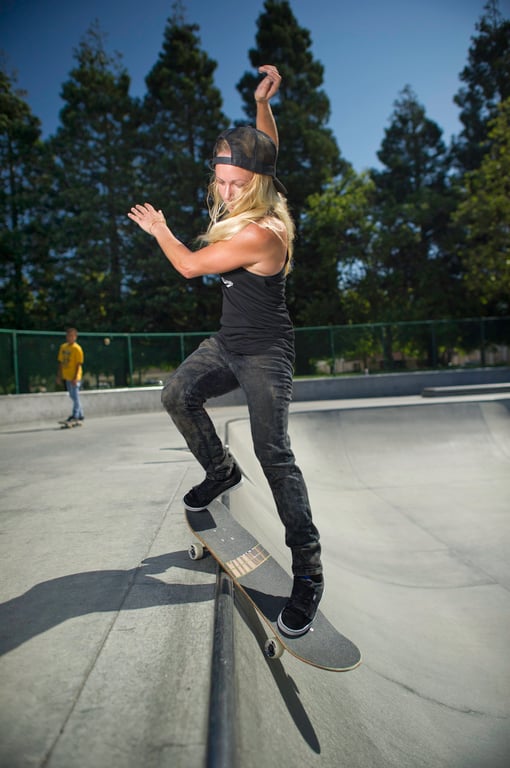 A skateboarder performing a Smith grind.