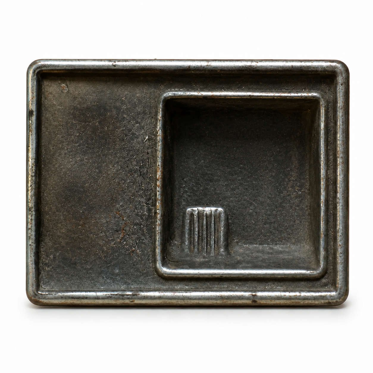 Isolated rectangular dark metal automobile ashtray with a worn chrome rim on a white museum catalog background.