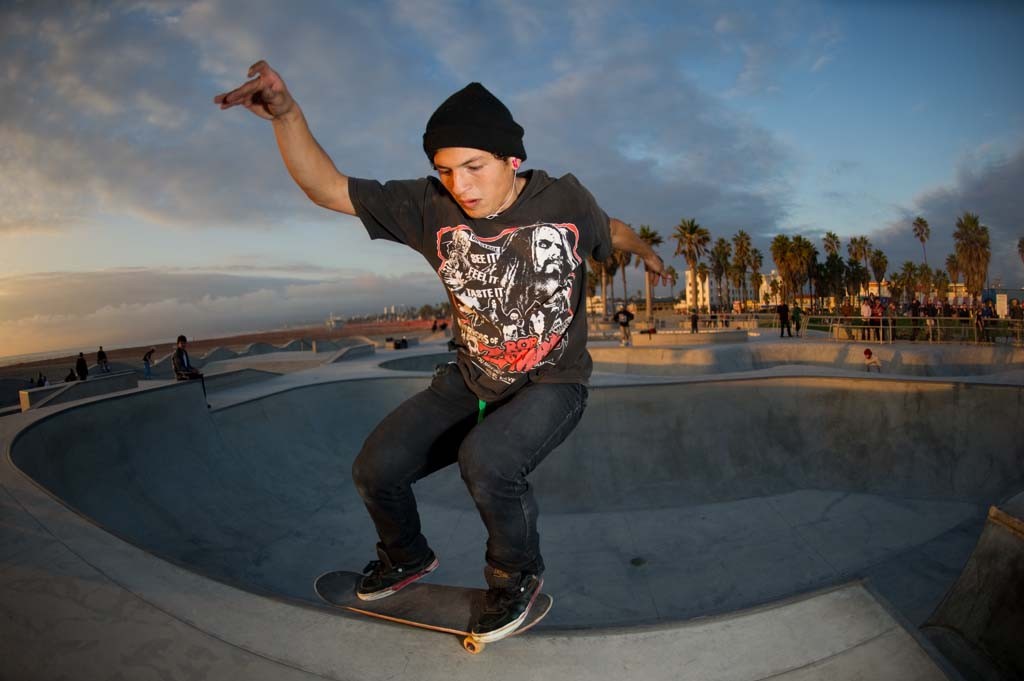 A skateboarder performing a Smith grind.