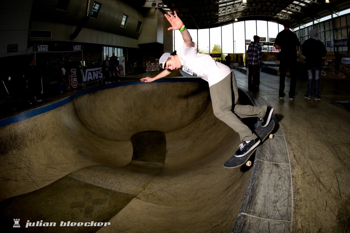 An unidentified skateboarder performing a Smith grind.