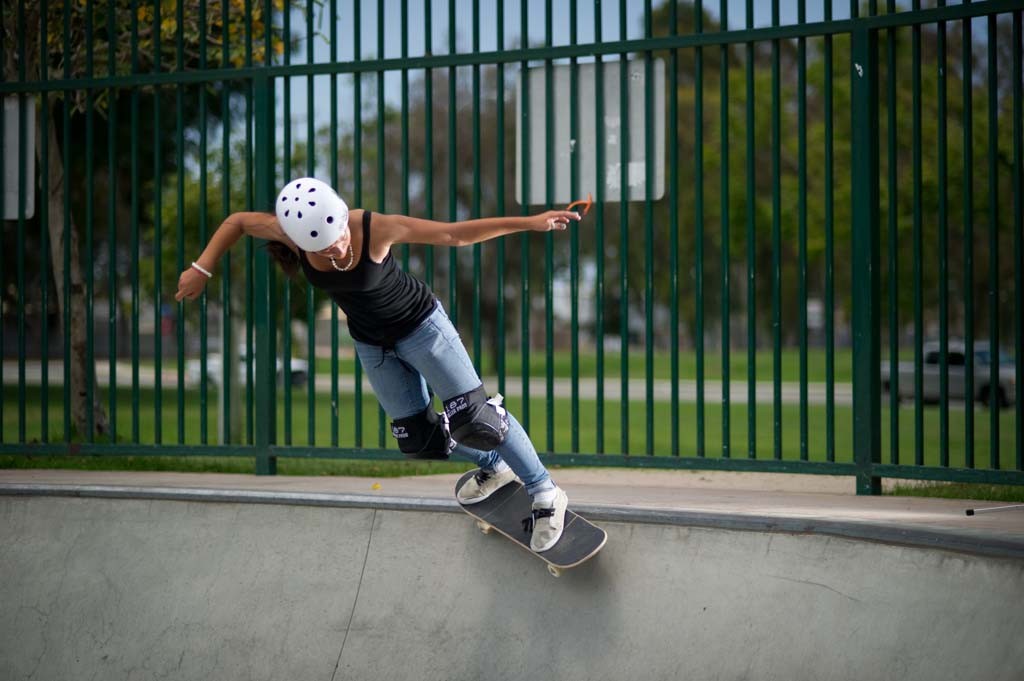 A skateboarder performing a Smith grind.