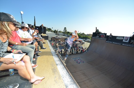 A skateboarder performing a Smith grind.