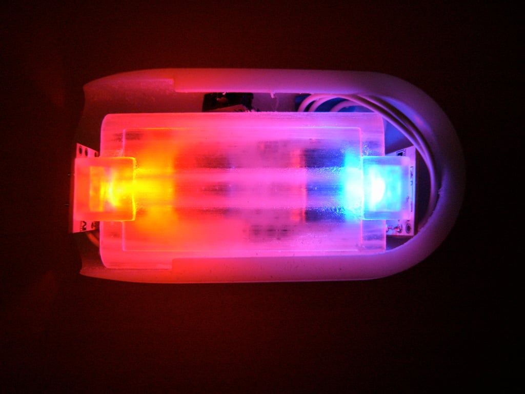 Open Kombolói showing a translucent internal assembly lit red at one end and blue at the other.