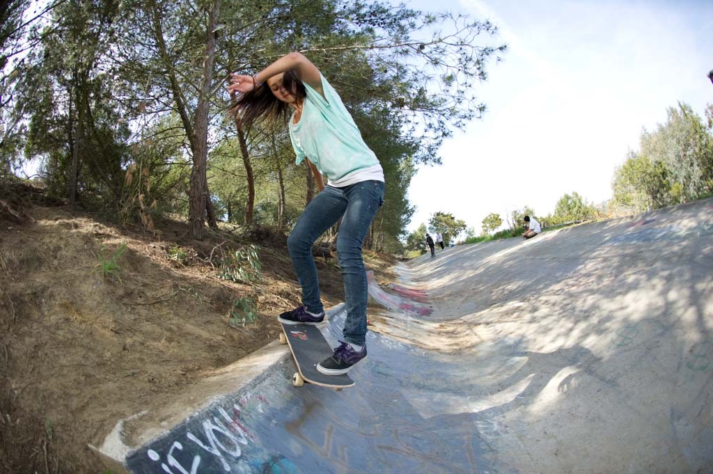 A skateboarder performing a Smith grind.