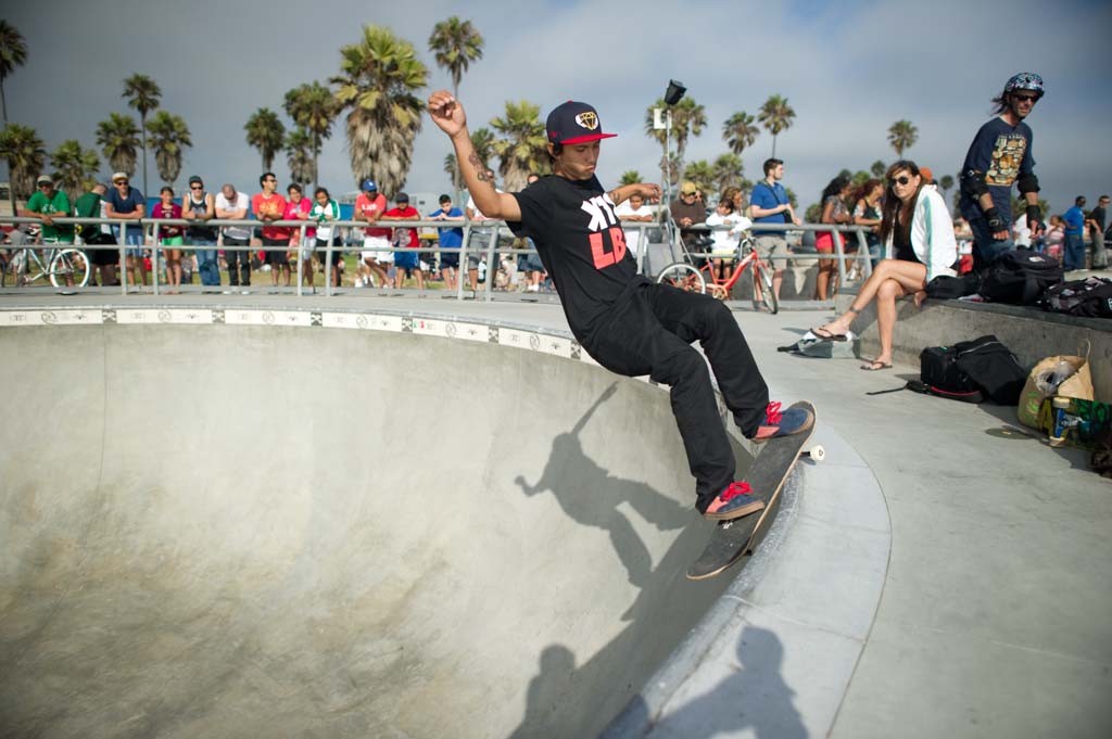 A skateboarder performing a Smith grind.