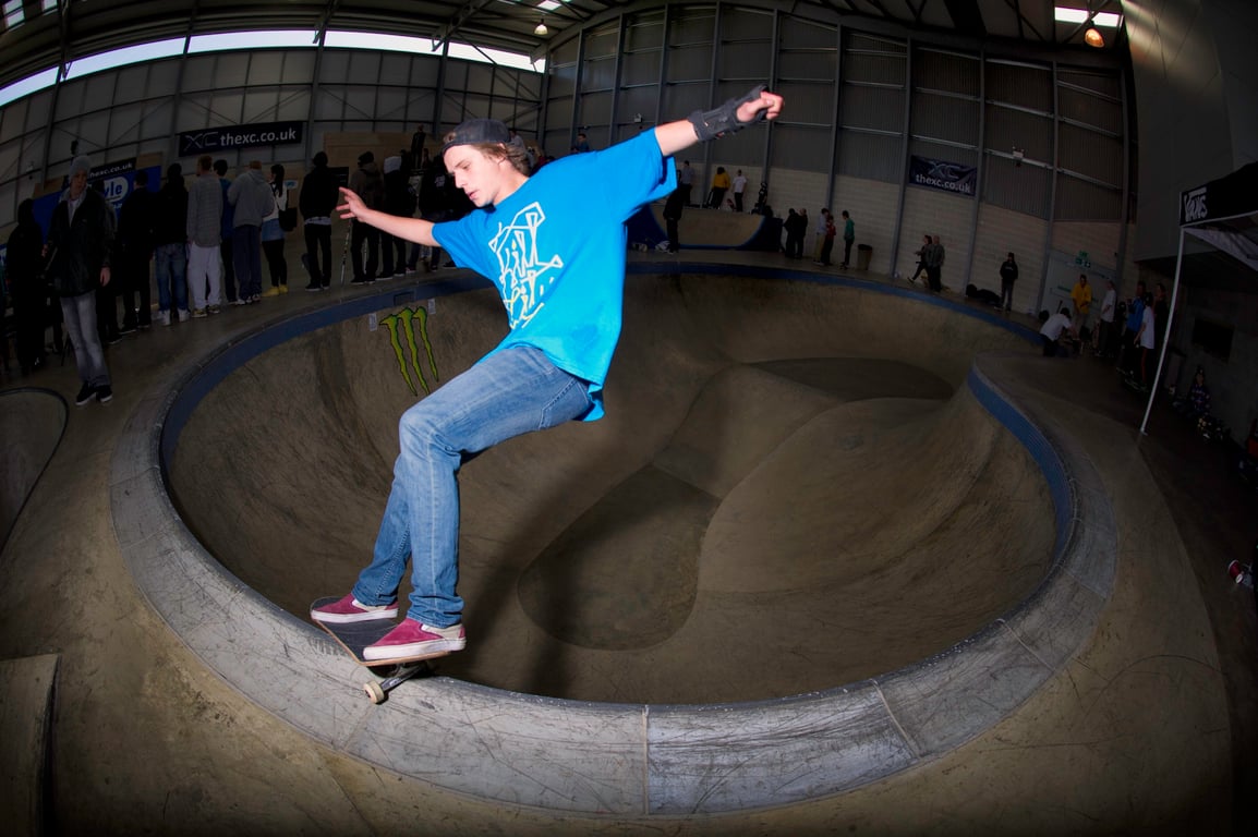 A skateboarder performing a Smith grind.