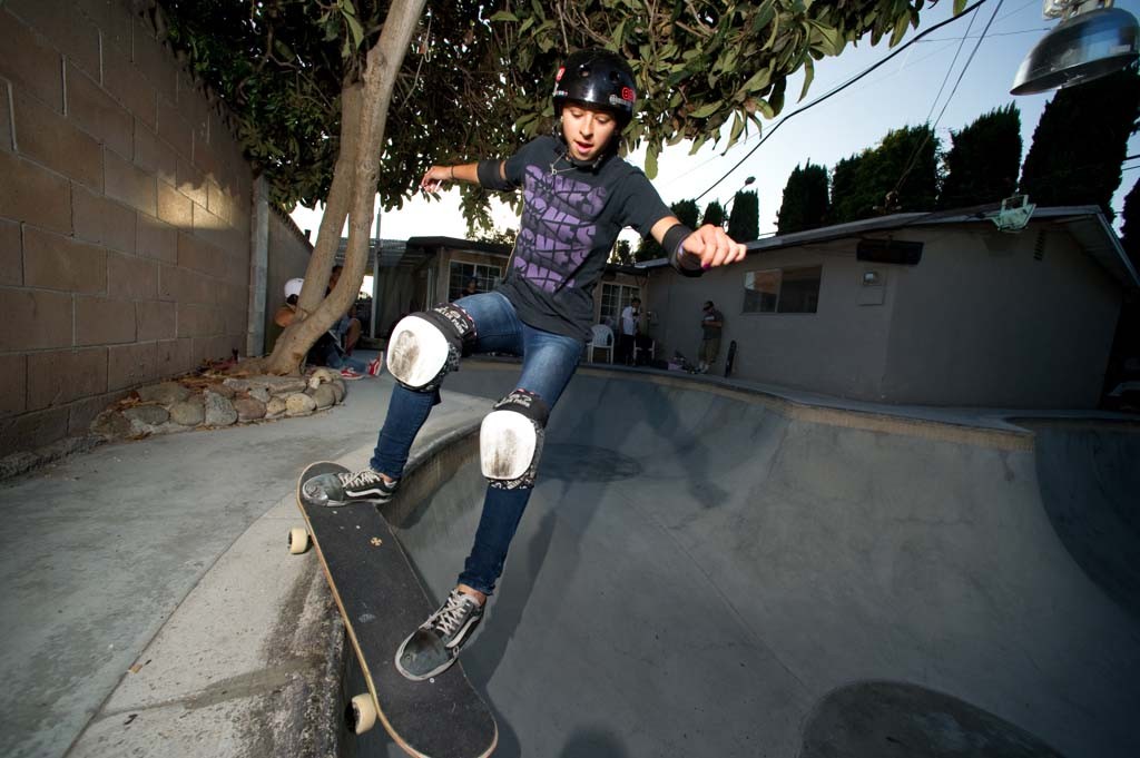 A skateboarder performing a Smith grind.