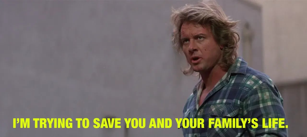 A still frame from the film They Live where the protagonist is punched for trying to save the world.