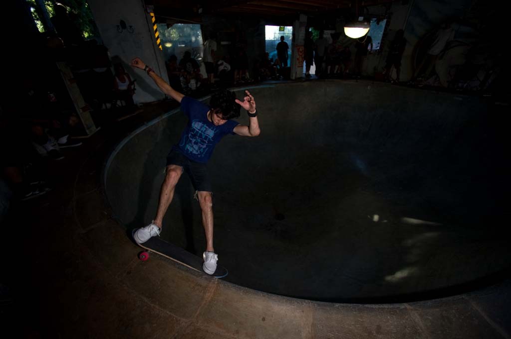 A skateboarder performing a Smith grind.