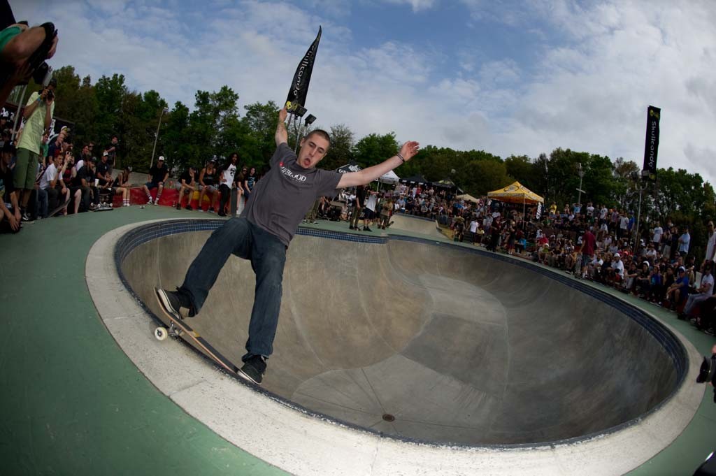 A skateboarder performing a Smith grind.