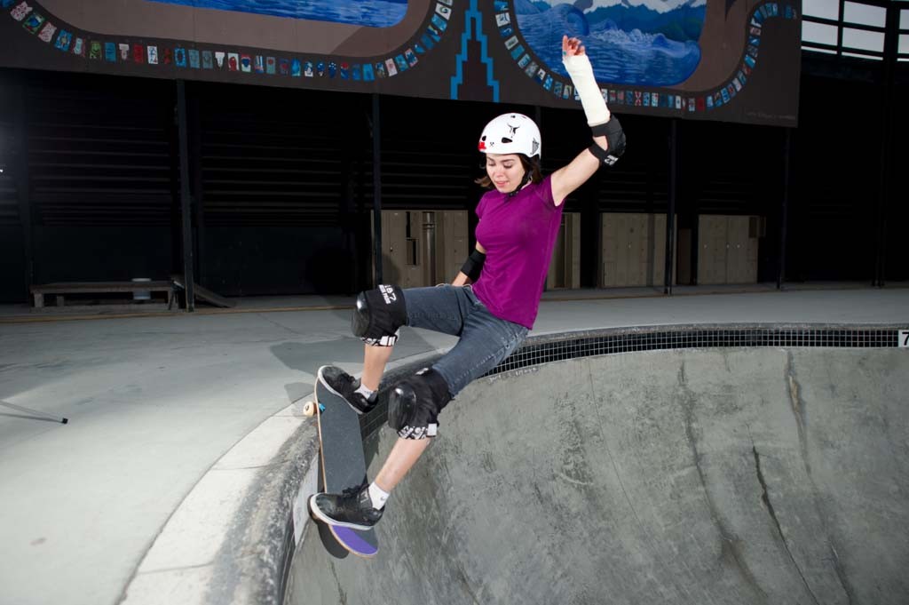 A skateboarder performing a Smith grind.