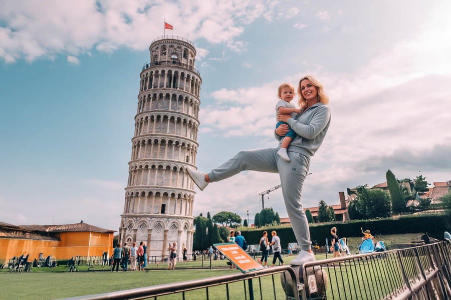 AI Generated image of a woman holding a baby holding the Leaning Tower of Pisa up with her foot