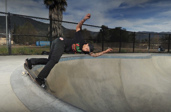 A skateboarder performing a Smith grind.