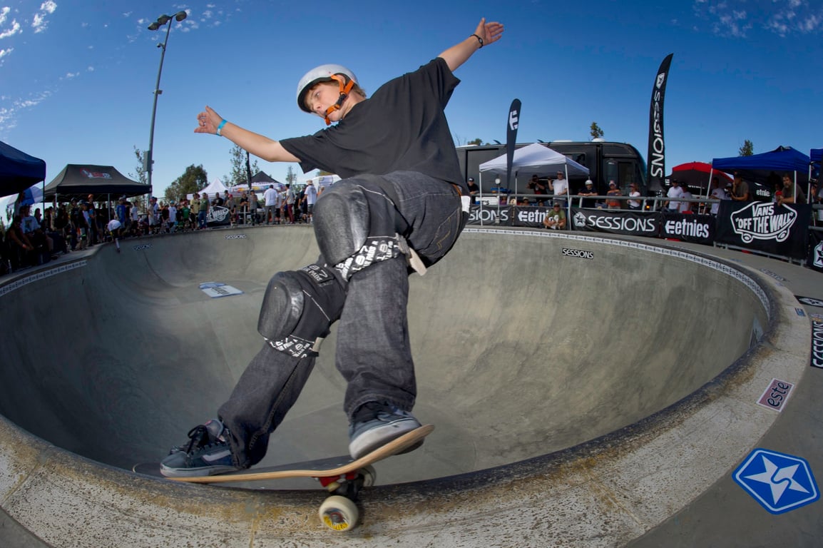 A skateboarder performing a Smith grind.