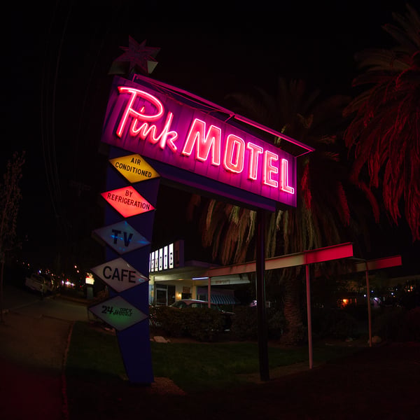 An exterior photo of the Pink Motel neon sign at night 2011