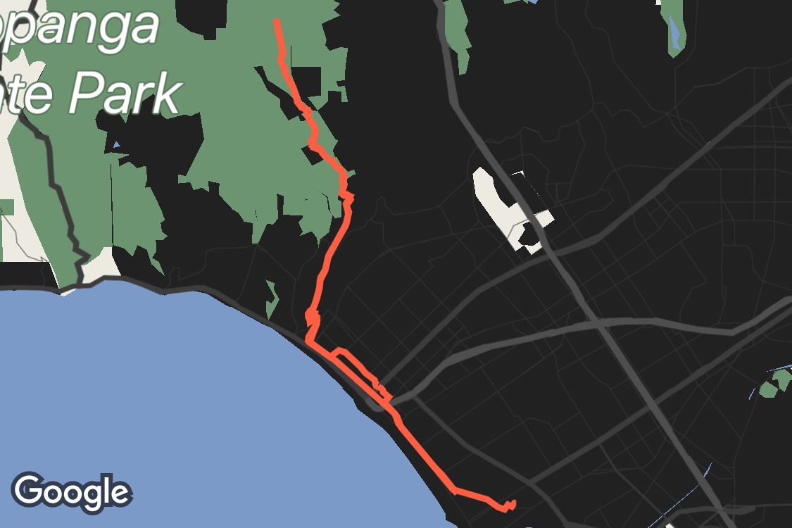 OMATA map-style study with an orange-red route, green parkland, dark streets and blue ocean near Santa Monica.