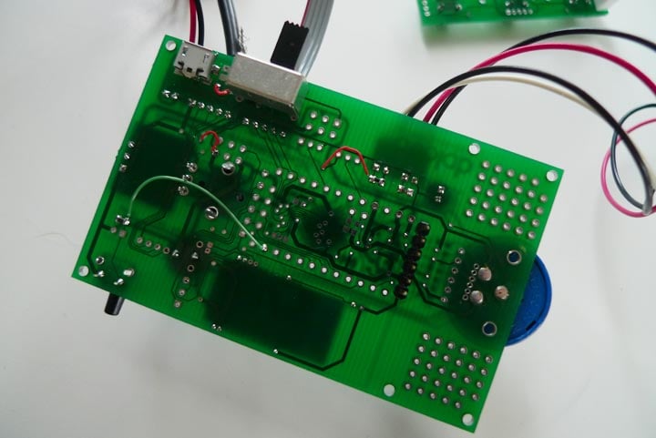 Underside of the Humbo custom circuit board, showing solder points, wiring, and the rotary-control connection.