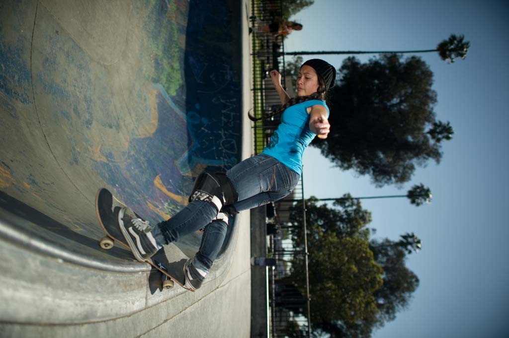 A skateboarder performing a Smith grind.