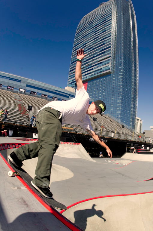 A skateboarder performing a Smith grind.