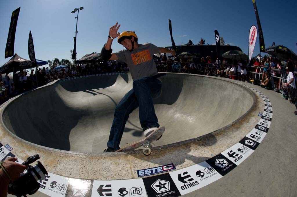 A skateboarder performing a Smith grind.