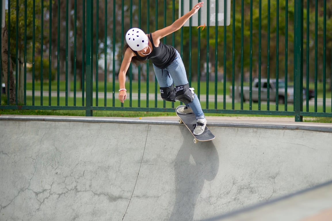 A skateboarder performing a Smith grind.