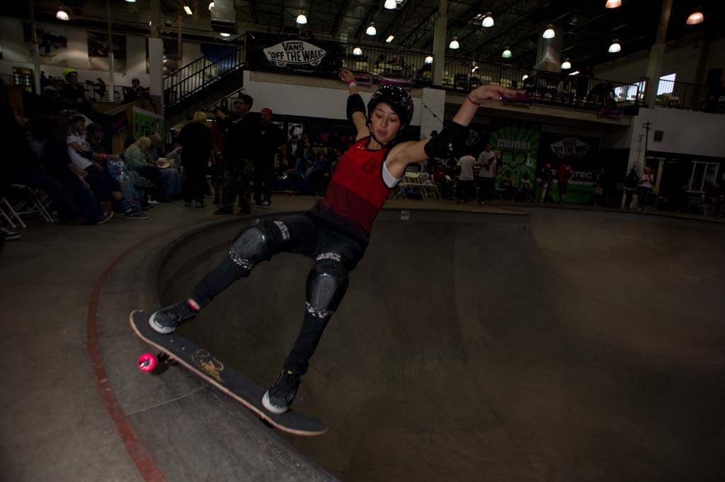 A skateboarder performing a Smith grind.