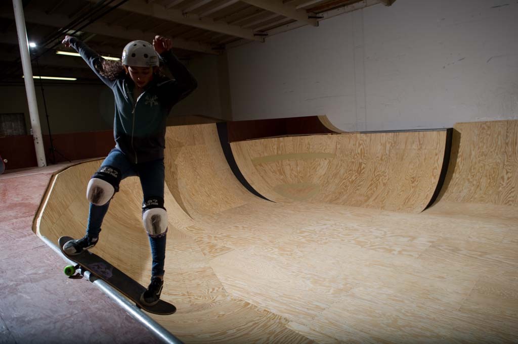 A skateboarder performing a Smith grind.