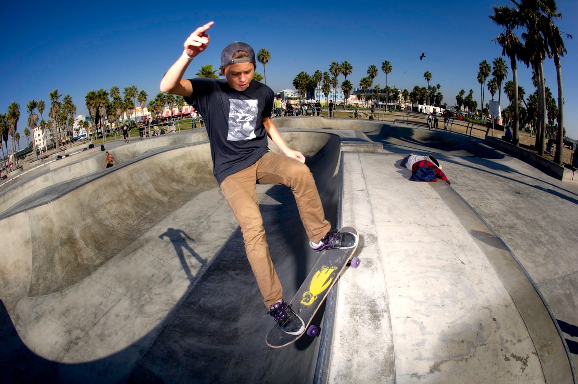 A skateboarder performing a Smith grind.