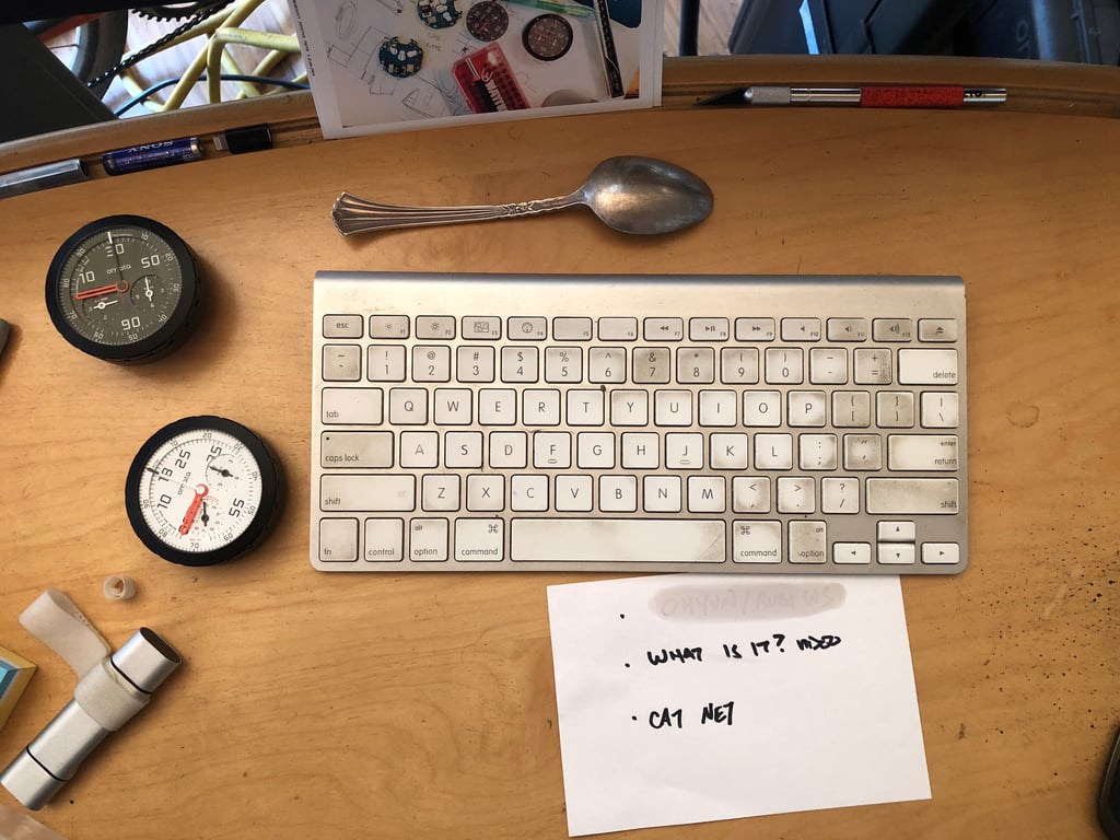 Two OMATA instruments, a keyboard, a spoon and handwritten notes.