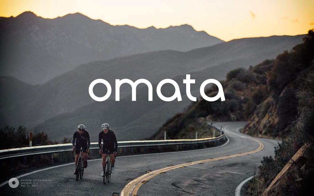 OMATA Brand Book v1.1 cover: two cyclists on a mountain road below the white wordmark.