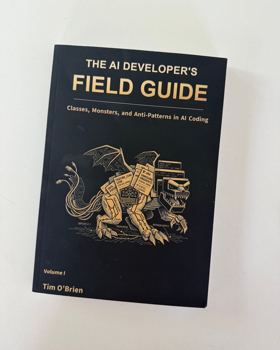Full photograph of the black front cover of The AI Developer's Field Guide, Volume I: Classes, Monsters, and Anti-Patterns in AI Coding by Tim O'Brien, with a gold mechanical dragon illustration.