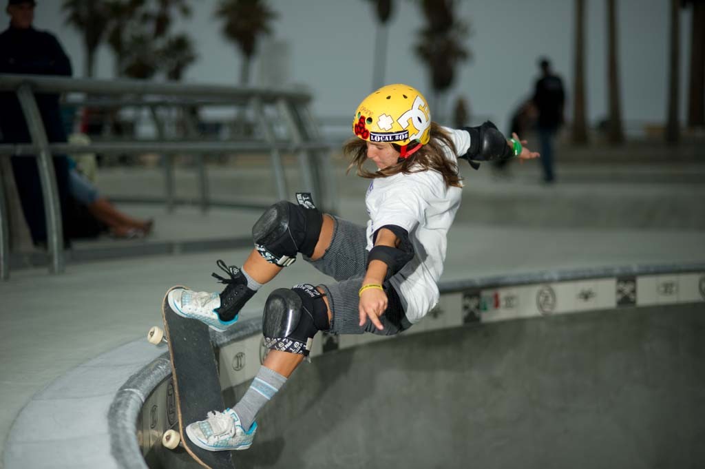 A skateboarder performing a Smith grind.