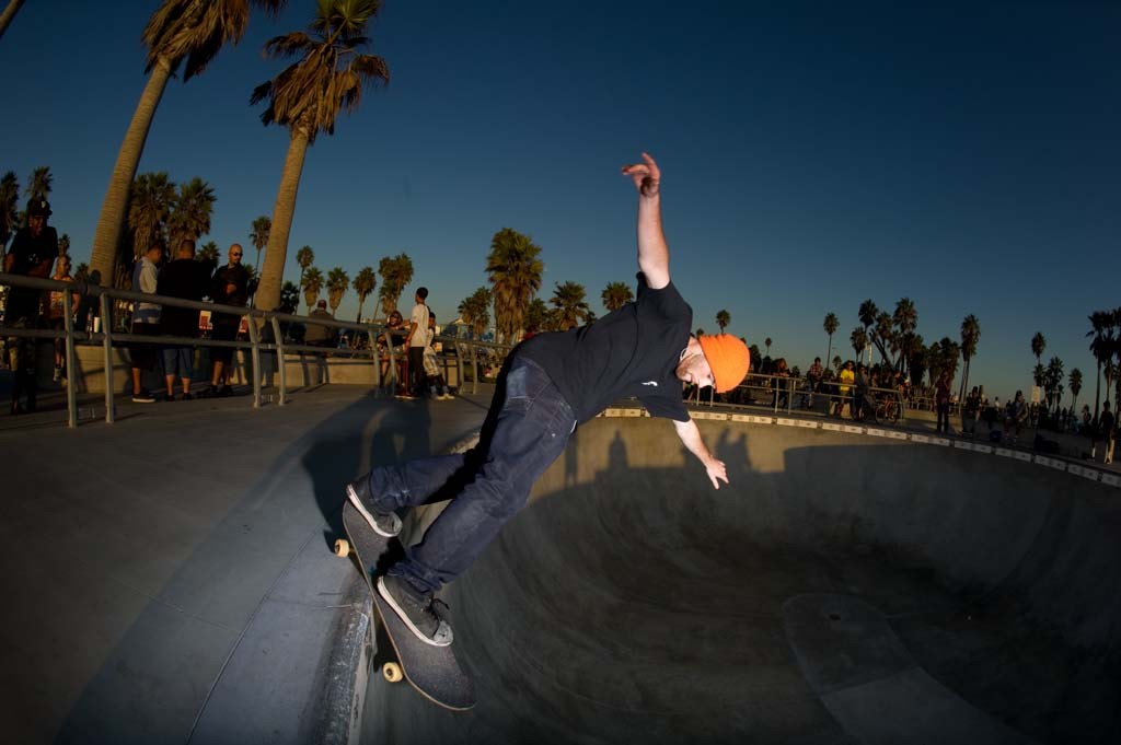 A skateboarder performing a Smith grind.