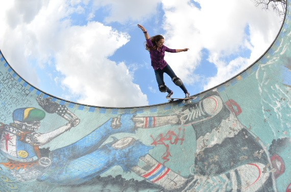 A skateboarder performing a Smith grind.