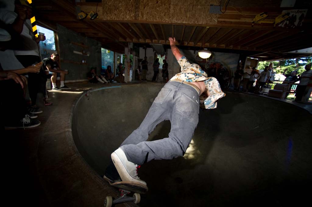 A skateboarder performing a Smith grind.