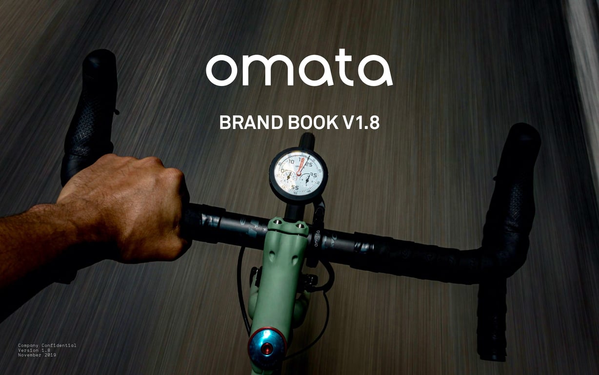OMATA Brand Book v1.8 cover: round instrument on green handlebars against a dark road.