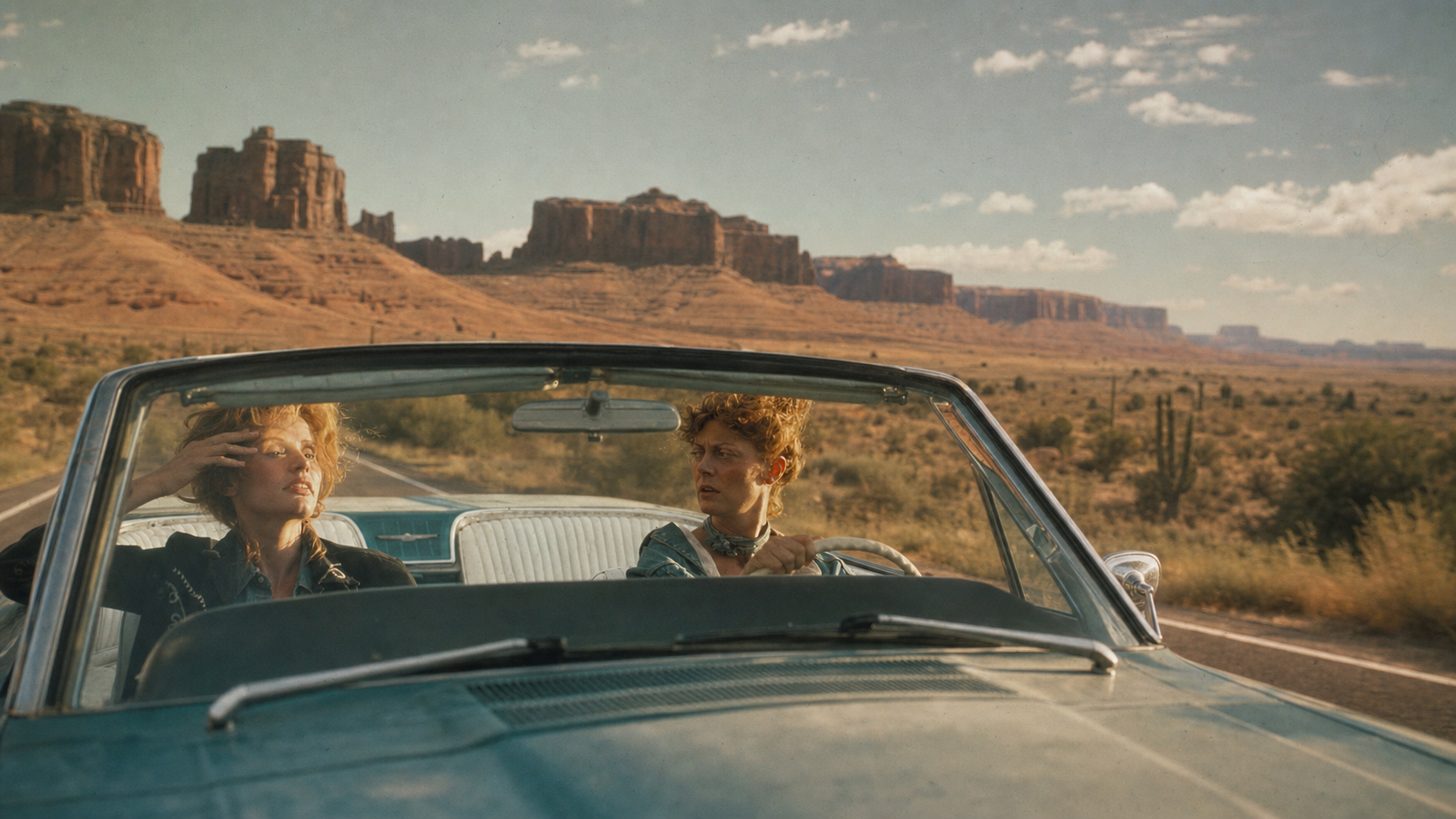 Film still from Thelma & Louise showing Thelma and Louise riding in a convertible through the desert.