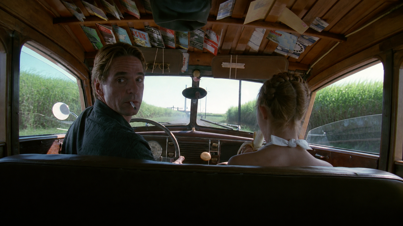 Film still from Lolita showing Humbert Humbert driving with Lolita in a vintage car.