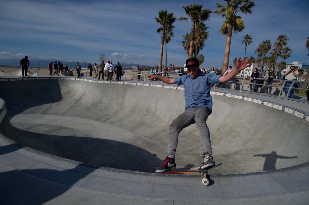 A skateboarder performing a Smith grind.