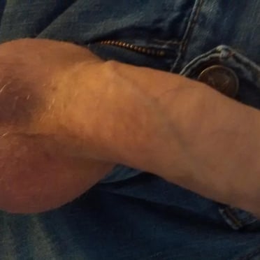 A juicy fat uncut white dick and big balls with a little bit of pubic hair.