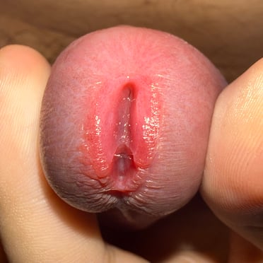 Close-up pic of a juicy, pink dick with a neatly shaved look.