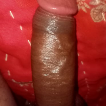 A thick and juicy dark dick pic with ample pubic hair.