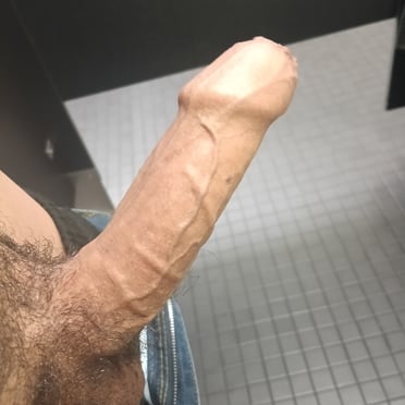 This beautiful, thick, veiny dick pic features prominent balls and a hairy bush.